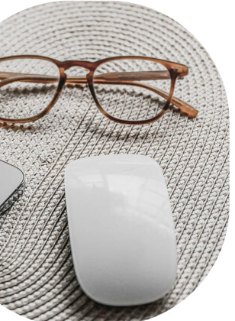 Escritorio de trabajo con teléfono, gafas y ratón